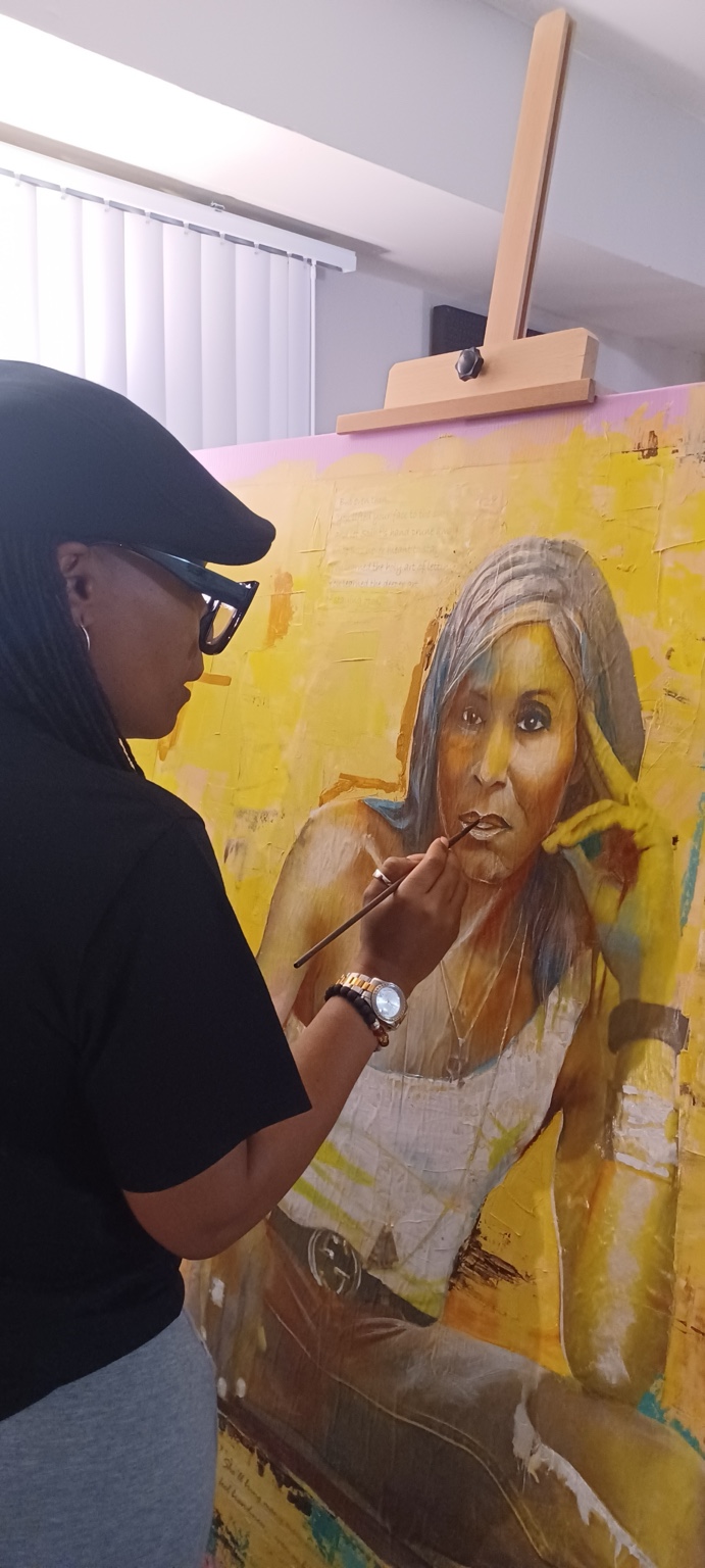 Eileen Lacy painting a canary-yellow mixed-media portrait with collaged excerpts from poetry and personal journal writings