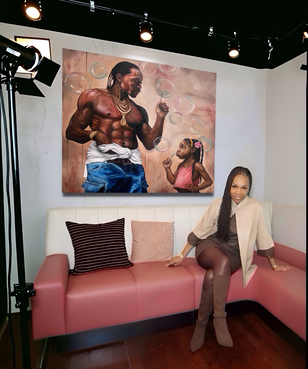 Eileen Lacy seated in her studio beneath her painting Girl Dad